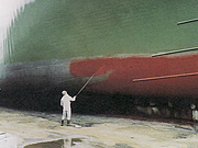 Spraying paint onto a ship bottom